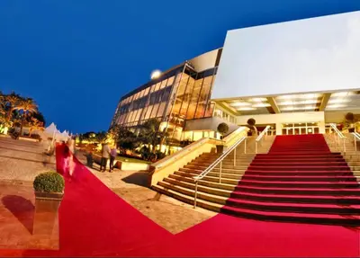 a red carpeted staircase to a building with people on it at Mini Studio - Le Panisse By SCLS Locations in Cannes