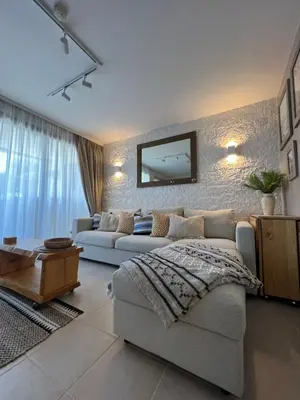 a living room with a couch and a tv on a wall at Cannes Villa Francia in Cannes