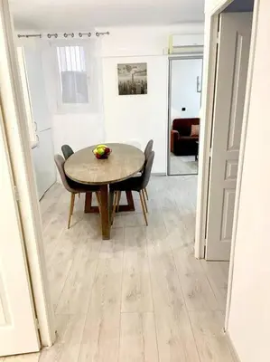 a dining room table and chairs in a room at Cœur de Cannes in Cannes