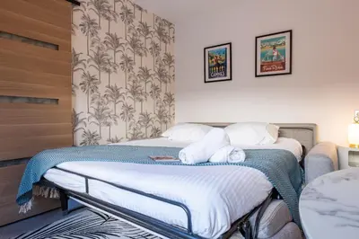 two beds in a hotel room with towels at RARE ! Studio with terrace 5min walk to the Palais in Cannes