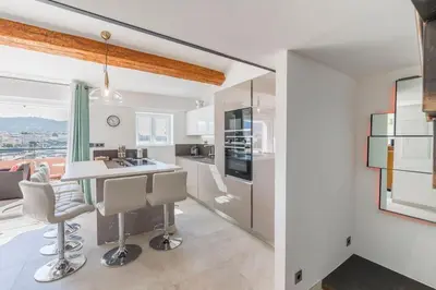 a kitchen with a table and chairs in a room at Facing old Port of Cannes Duplex WOW this view Olam Properties in Cannes