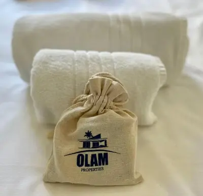 a bag of towels sitting on a bed at Croisette 1 mn 2 BR w/ terrace Olam Properties in Cannes