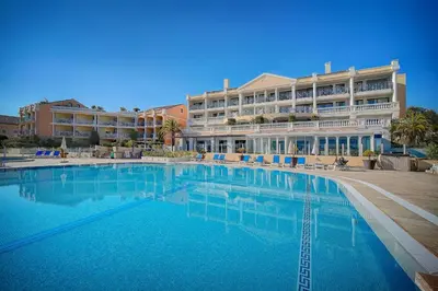 a large swimming pool in front of a hotel at Villa Francia Cannes in Cannes