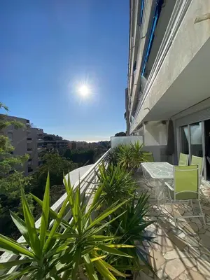 a balcony with chairs and plants on a building at 3 Pièces avec grande terrasse in Cannes