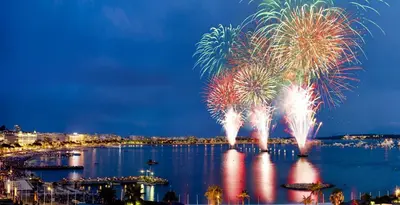 a firework display over a body of water at Deluxe 2 bedroom apartment in Cannes