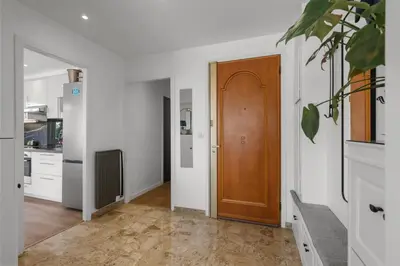 a hallway with a wooden door in a kitchen at Cannes Beach Access, Private Room in Shared 3-Bedroom Apartment, Private Bathroom, Living Room with Sea View Suite Parentale salle de bain privée accès plages & vue mer du salon dans appartement partagé chez l'habitant in Cannes