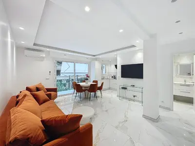 a living room with a couch and a table at Résidence Lacour in Cannes