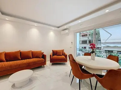 a living room with a couch and a table and chairs at Résidence Lacour in Cannes
