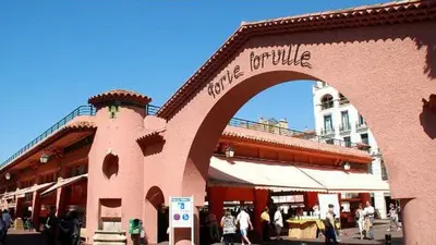 a building with an arch with people walking in front of it at Studio Cannes centre in Cannes