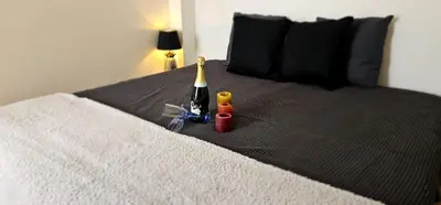a bed with a bottle of wine and other toys on it at Cannes, Sea View, Beach Access, 3-Bedroom Apartment, 100 m2, 3 Bathrooms, Sleeps 6, 100 meters from Beach in Cannes