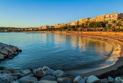 a view of a beach with rocks and buildings at Renovated studio near the CROISETTE in Cannes
