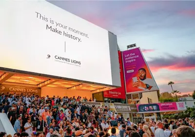 a crowd of people standing in front of a large billboard at TOP renovated 1 bedroom near Palais 2P1 by RIVAEVENT in Cannes