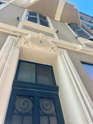 a building with a green door on the side of it at TOP renovated 1 bedroom near Palais 2P1 by RIVAEVENT in Cannes
