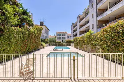 a swimming pool in the middle of a building at Charming apartment with balcony-pool - Cannes in Cannes
