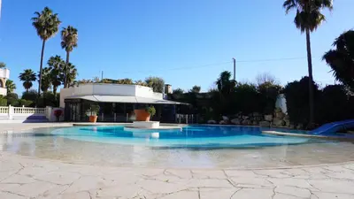 a swimming pool with blue water in front of a building at Appartement 426, vue mer et piscine by Palmazur in Cannes