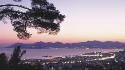 a view of a city and the ocean at sunset at Bessons in Cannes