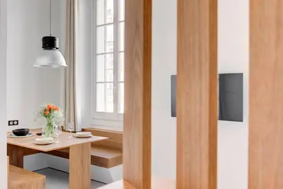 a living room with a table and a window at Immogroom - 2 min du palais - Studio - Luxury - AC in Cannes