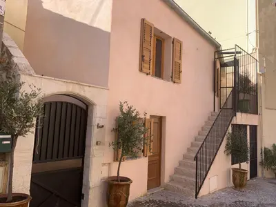 a building with a staircase and a door and some plants at Chante Brise Studio in Cannes