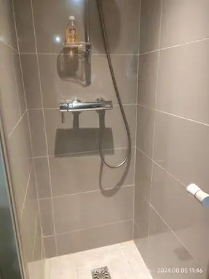 a shower with a hose in a bathroom at Chante Brise Studio in Cannes