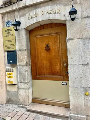a wooden door on the side of a building at LB Vacation Rentals I Superieure Room 22m2 - Spacious I Casa d'Azur in Cannes
