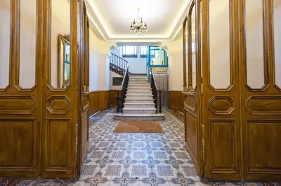 a hallway with wooden doors and stairs in a building at Luxurious StudioLoft 3 MINUTES FROM LA CROISETTE in Cannes
