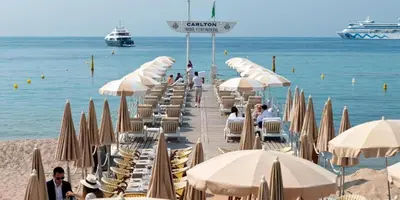 a bunch of chairs and umbrellas on a beach at 2P Between Croisette Beaches and Antibes Street in Cannes