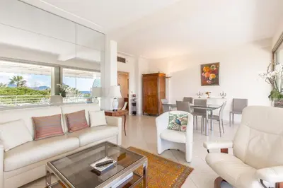 a living room with a couch and a table at Sea View 95m Apartment with Large Terrace Cannes Croisette in Cannes
