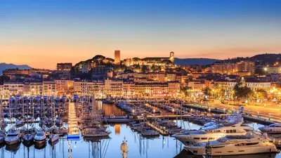 a group of boats docked in a marina at night at Residence Aout 21 in Cannes