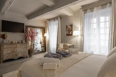 a large bedroom with a large bed and a tv at Hotel particulier Croisette in Cannes