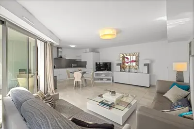 a living room with a couch and a table at VIP 2 chambres, 2 salles de bain et 2 WCs Palais des Festivals Croisette in Cannes