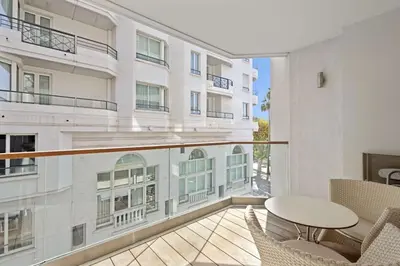 a balcony with a table and chairs and a building at Cannes Croisette 2 bedrooms - 7C3 in Cannes