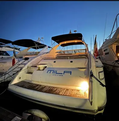 a white boat is parked in a marina at yacht 17M Princess V52 Cannes port canto 3 chambres AC in Cannes