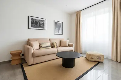 a living room with a couch and a table at Mediterranean Cosy Studio in Cannes