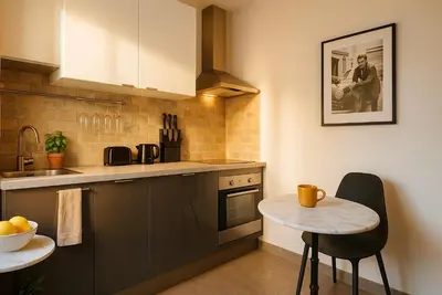 a kitchen with a small table and a counter at Croisette Cosy Studio in Cannes