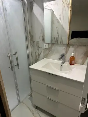 a white bathroom with a sink and a shower at Cannes Croisette in Cannes