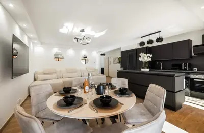 a dining room and kitchen with a table and chairs at Prestigious apartment in Cannes in Cannes