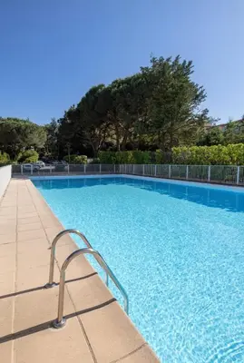 a blue swimming pool with a metal handrail in a resort at Prestigious apartment in Cannes in Cannes