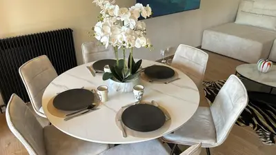a white table with chairs and a white vase with flowers at Prestigious apartment in Cannes in Cannes