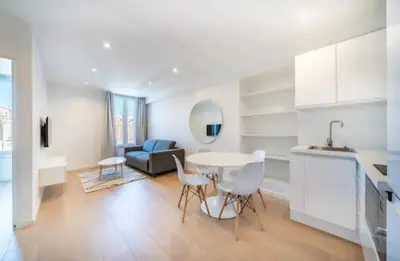 a kitchen and living room with a table and chairs at Beautiful 2-room apartment on the Croisette in Cannes in Cannes