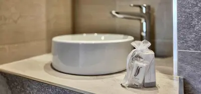a sink in a bathroom with a plastic bag on a counter at LX147 Studio lumineux centre, confort & autonomie in Cannes