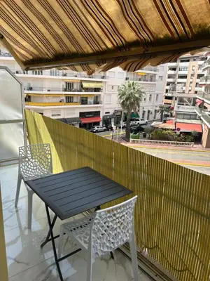 a table and chairs on a balcony with a view of a city at Normandy in Cannes