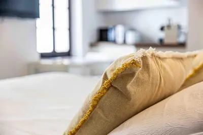 a pillow sitting on top of a bed at 2 Pcs Plein Coeur Ville, Palace Festivals, Port Plages in Cannes