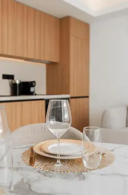 a table with two wine glasses and a plate on it at T2 Neuf et chic à deux pas de la Croisette in Cannes