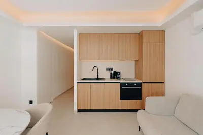 a living room with a couch and a kitchen at T2 Neuf et chic à deux pas de la Croisette in Cannes