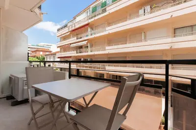 a balcony with a table and chairs and a building at T2 Neuf et chic à deux pas de la Croisette in Cannes