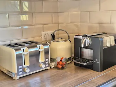a kitchen counter with a toaster and a tea kettle at Villa Lou San Peyre, Cannes et Mougins, 4 km des plages in Le Cannet