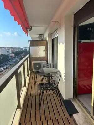 a balcony with a table and chairs on it at Le FRAGONNARD in Cannes