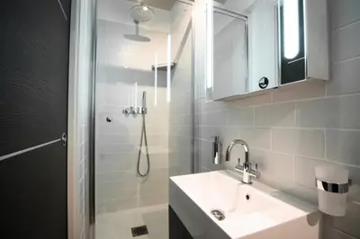 a white bathroom with a sink and a shower at Résidence 3p Pointe Croisette, Au Calme, Plages à Pied - 3P pointe Croisette, au calme, plages à pied MAE-1883 in Cannes