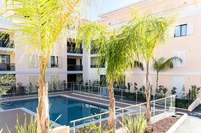 a swimming pool in front of a building with palm trees at Résidence 2p Avec Piscine Au Palm Beach - 2P avec piscine au Palm Beach MAE-2313 in Cannes