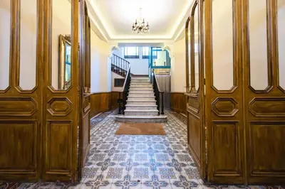 a hallway with wooden doors and stairs in a building at Résidence Superbe 3 Pièces à 3 Min De La Croisette - Superbe 3 Pièces à 3 min de la Croisette MAE-2813 in Cannes